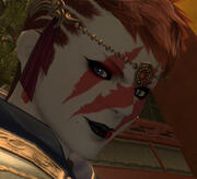 A close up portait of Skyltbraena Wilfswys. Fae is wearing red lipstick and smiling over faer shoulder.